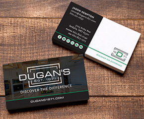 Dugan's business cards displayed on a wood table