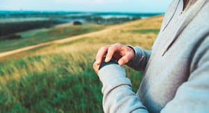 man wearing watch in field