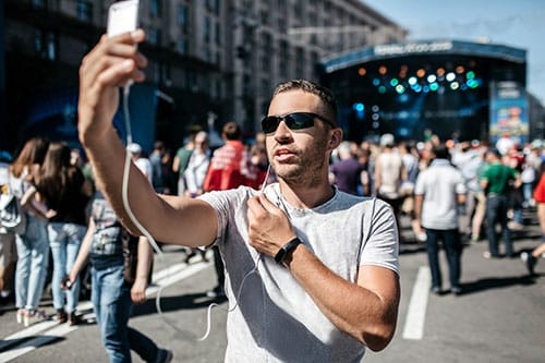 man holding phone taking live video