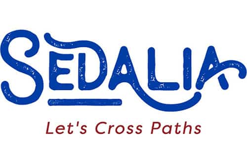 City of Sedalia logo in blue above Let's Cross Paths in red