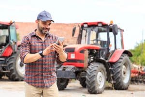 Man on social media by a tractor