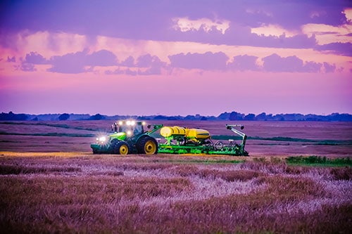 Tractor in a Missouri field at sunset
