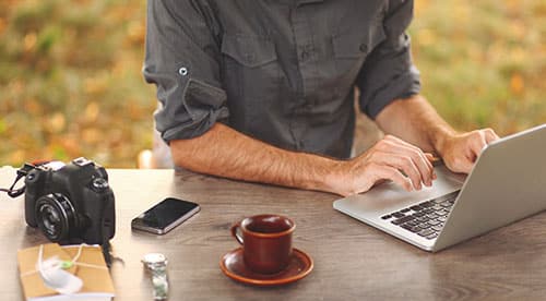 young man typing on a laptop